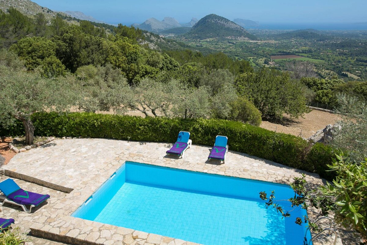 A swimming pool with a view of mountains and trees