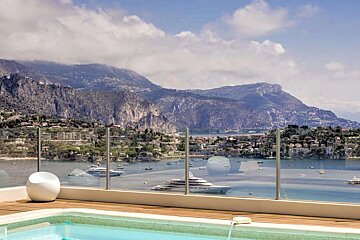 A swimming pool with a view of the ocean and mountains