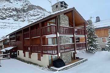 A range rover is parked in front of a snow covered building