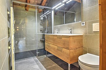 A bathroom with two sinks and a toilet
