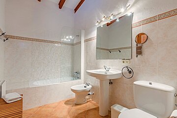A bathroom with a sink toilet and mirror