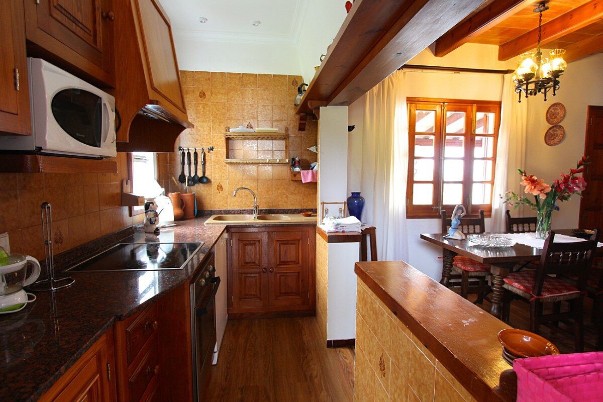 A kitchen with a stove top oven and a microwave