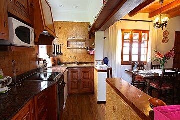 A kitchen with a stove top oven and a microwave