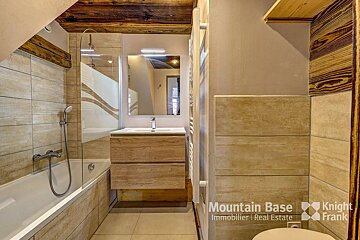 A bathroom with a knight frank logo on the wall