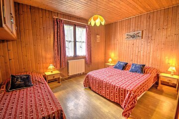 A bedroom with two beds and a picture of a plane on the wall