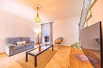 A living room with a couch a table and a television