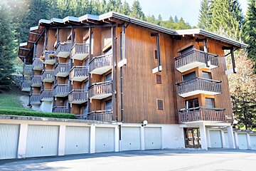A snowmobile is parked in front of a large building