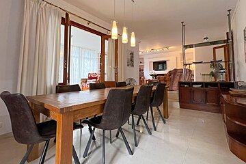 A living room with a couch and two chairs