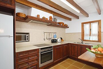 A kitchen with wooden cabinets and a white refrigerator