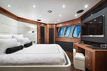 A bedroom with a large bed and a flat screen tv