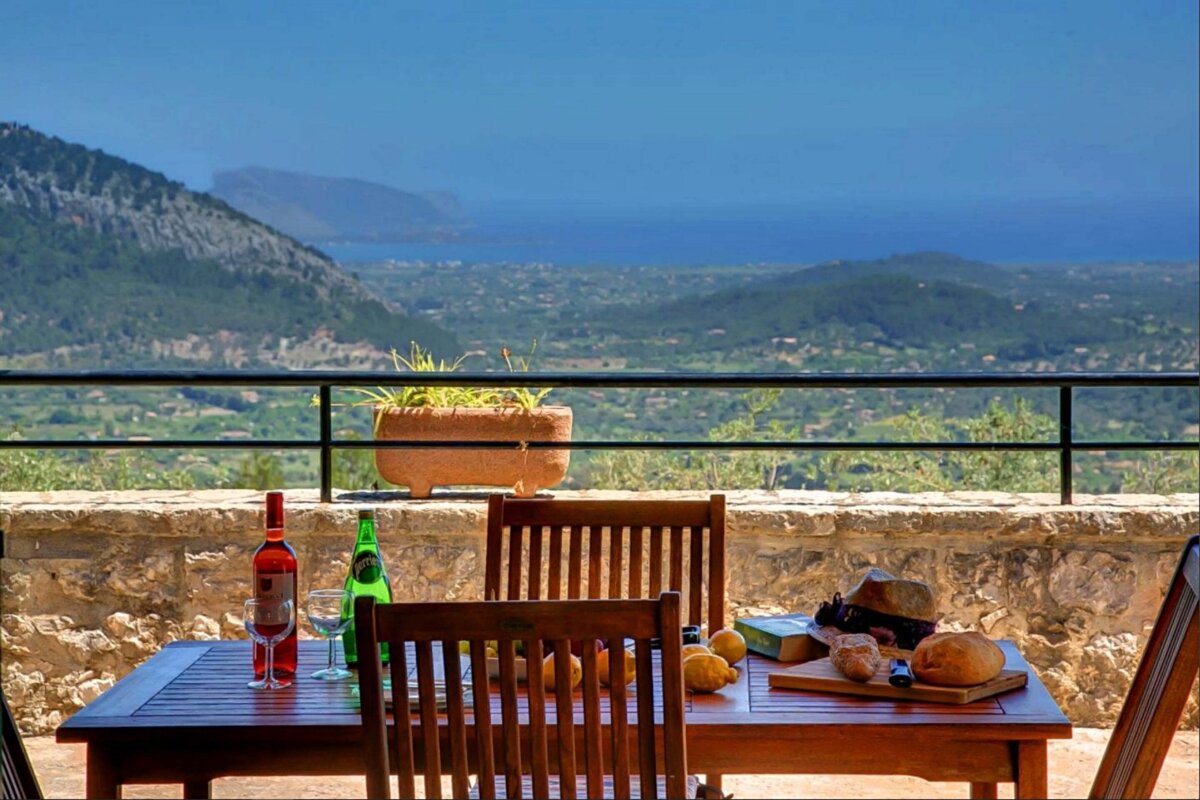 A table with a bottle of wine and a book on it