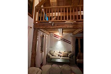 A living room with a couch and skis on the wall