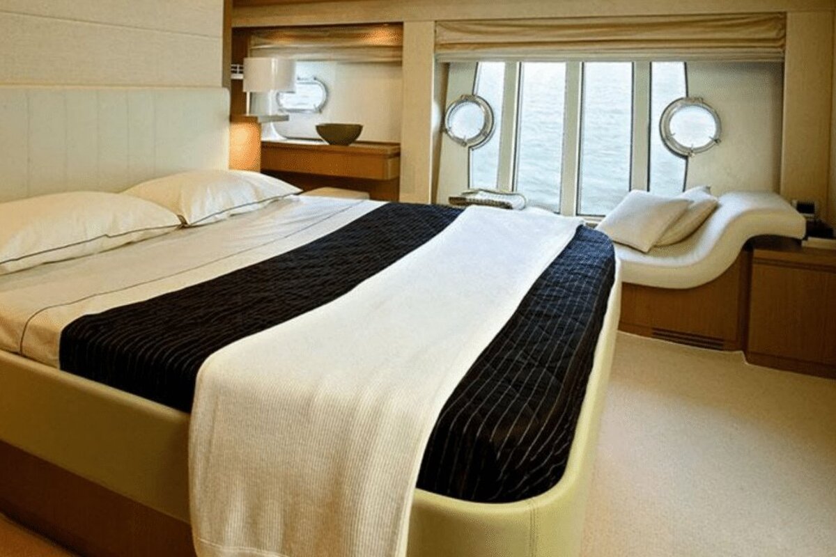 A bedroom with a large bed and a large window