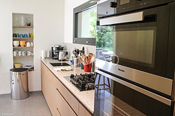 A kitchen with a stove top oven that says miele on it