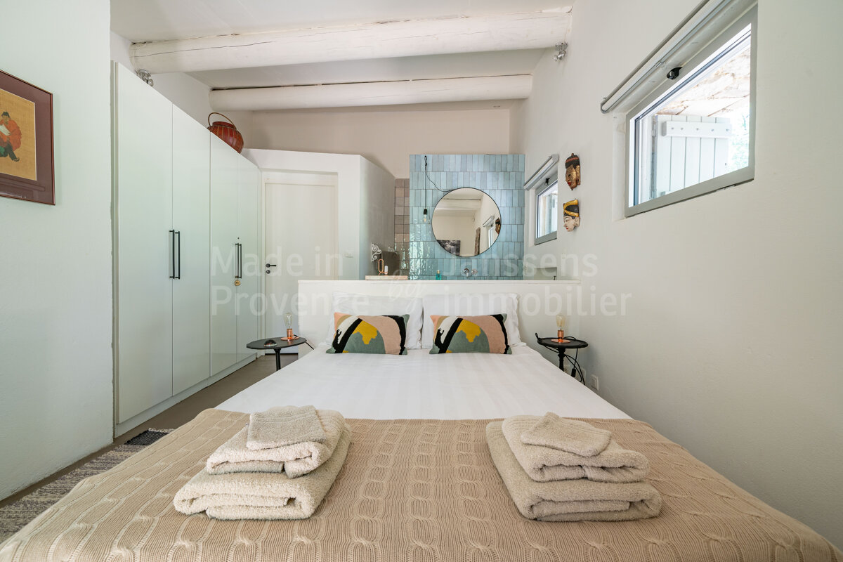A bedroom with a bed and a sign that says made in provence immobilier