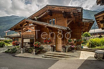 A picture of a wooden house with the number ten80 on it