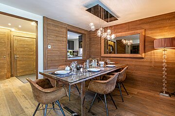A dining room table with plates and glasses on it