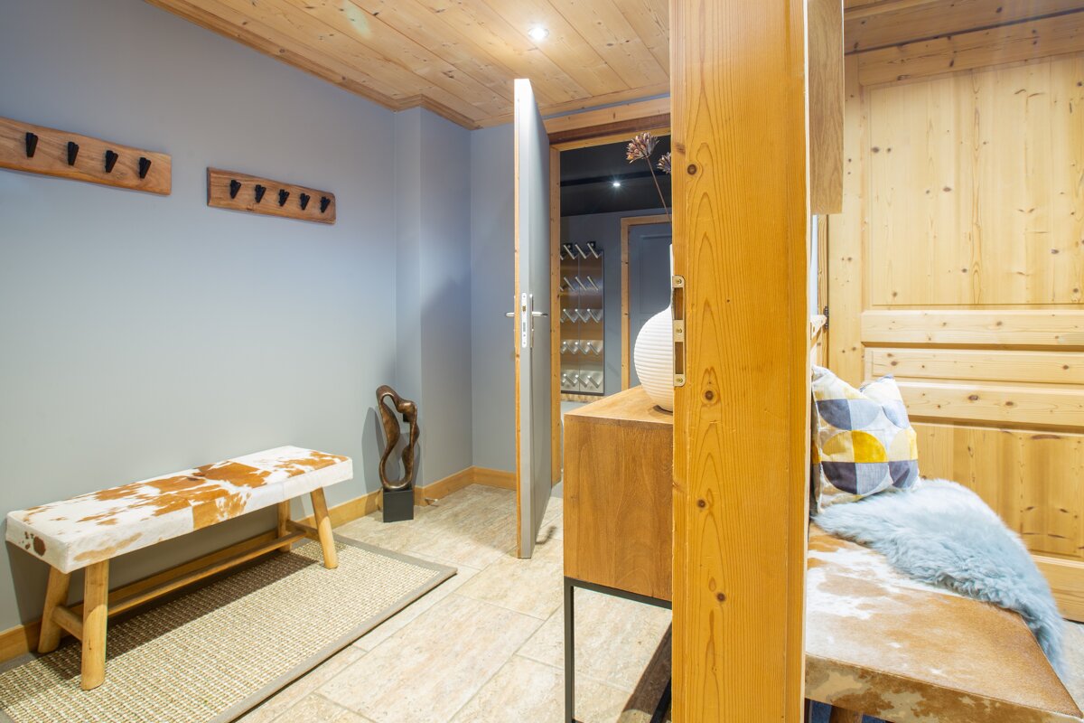 A hallway with a cowhide bench and a mirror