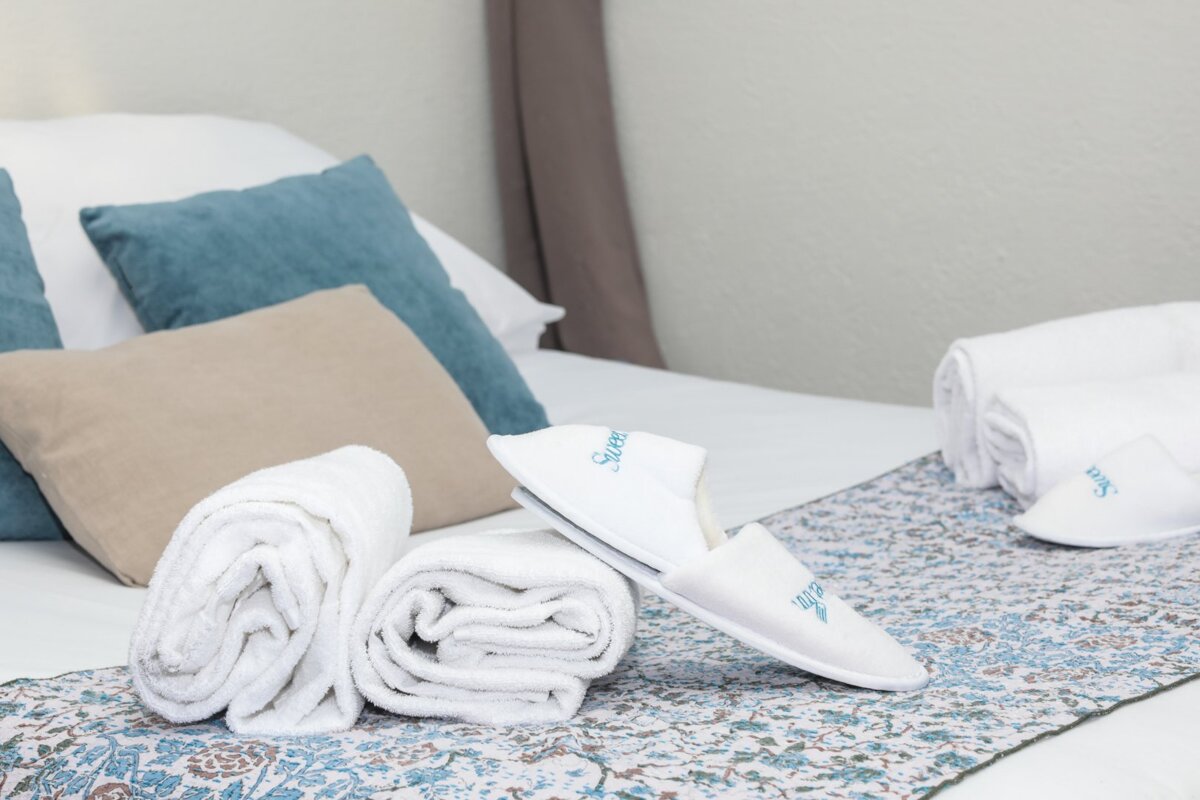 A pair of white slippers with the word sleep embroidered on them