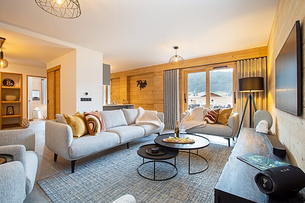 A living room with a couch and two coffee tables