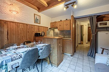 A kitchen with wooden cabinets and a stove top oven