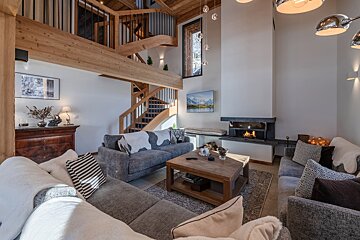 A living room with a couch a coffee table and a fireplace