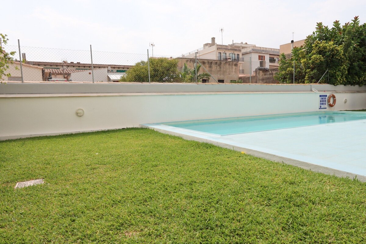 A swimming pool with a life preserver on the side of it