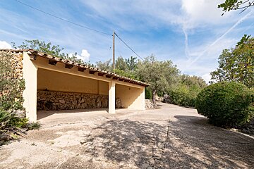 A building with a stone wall and a tiled roof