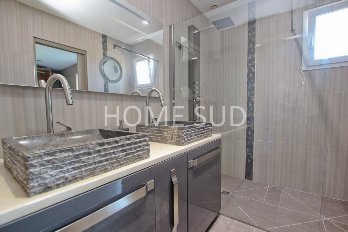 A bathroom with two sinks and a sign that says home sud