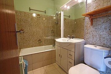 A bathroom with a sink toilet and bathtub