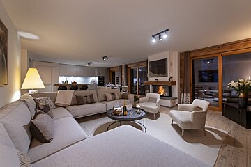 A living room with a couch and chairs and a fireplace