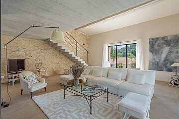 A living room with a staircase leading up to the second floor