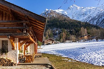 A snowy landscape with a mountain in the background