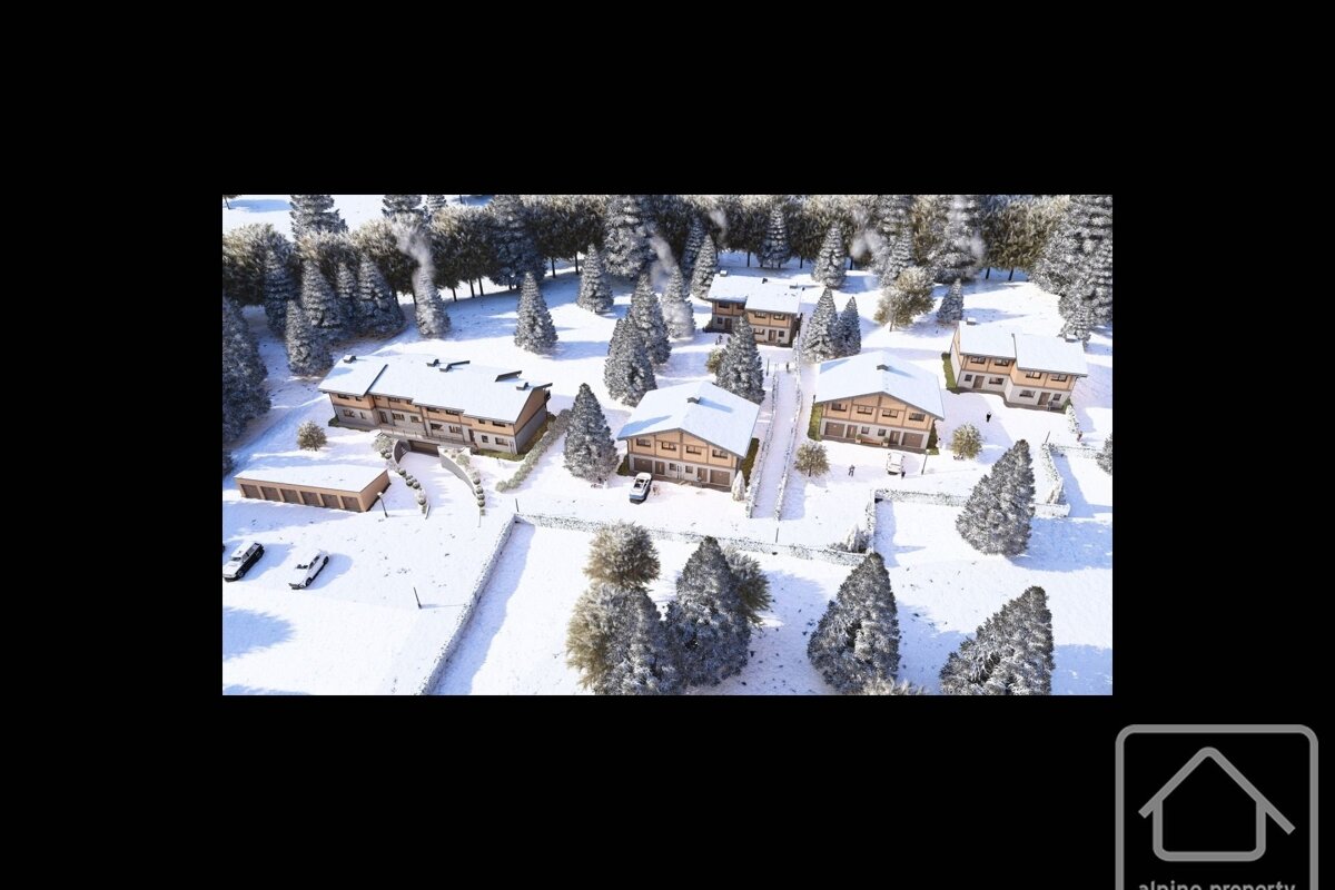 An aerial shot of a snow-covered village with numerous wooden chalets, frosted pine trees, and smoke rising from chimneys.