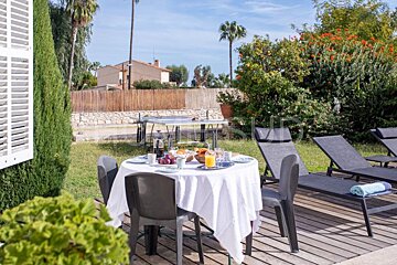 A table with a white table cloth and a plate of food on it