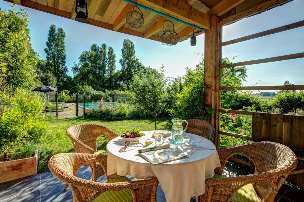 A table with a white table cloth and a pitcher of water on it