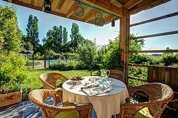 A table with a white table cloth and a pitcher of water on it
