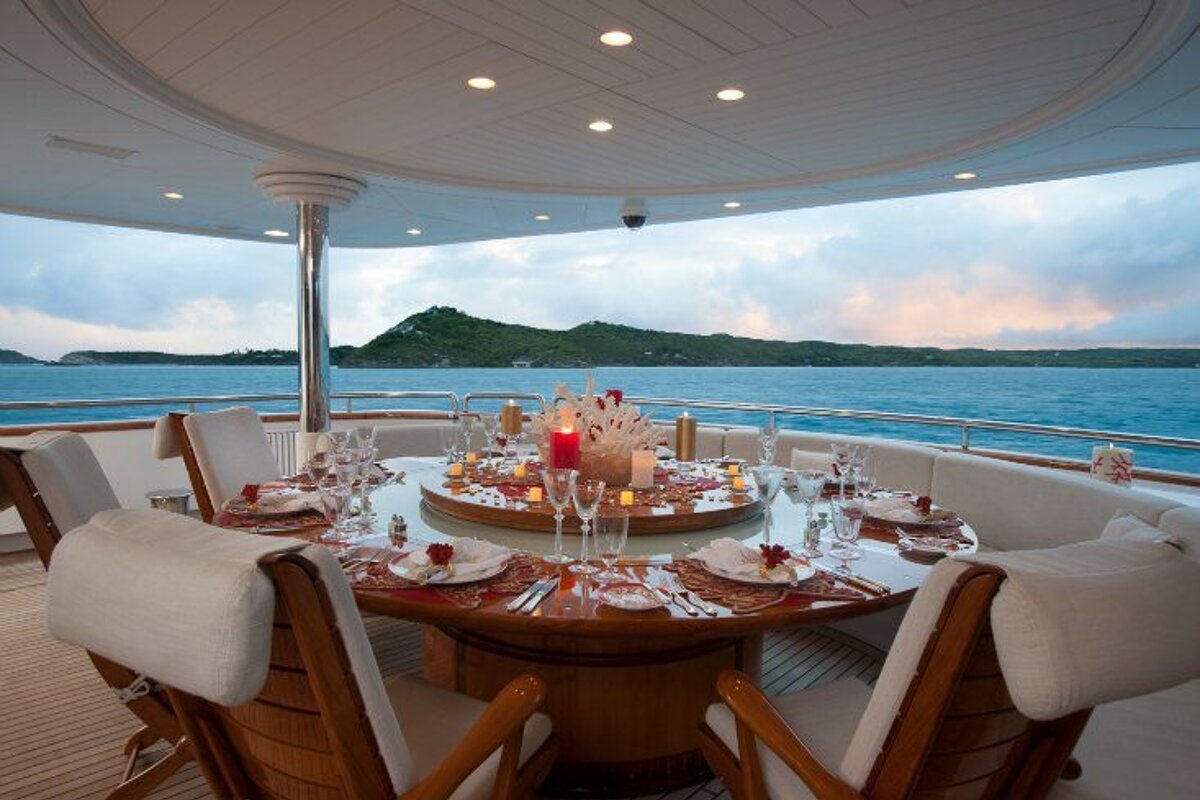 A table set for a dinner on a boat overlooking the ocean