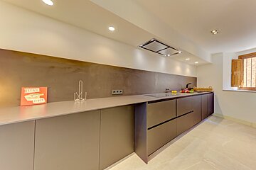 A kitchen with a sign on the counter that says