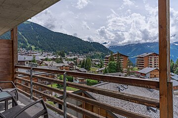 A balcony with a view of a mountain town