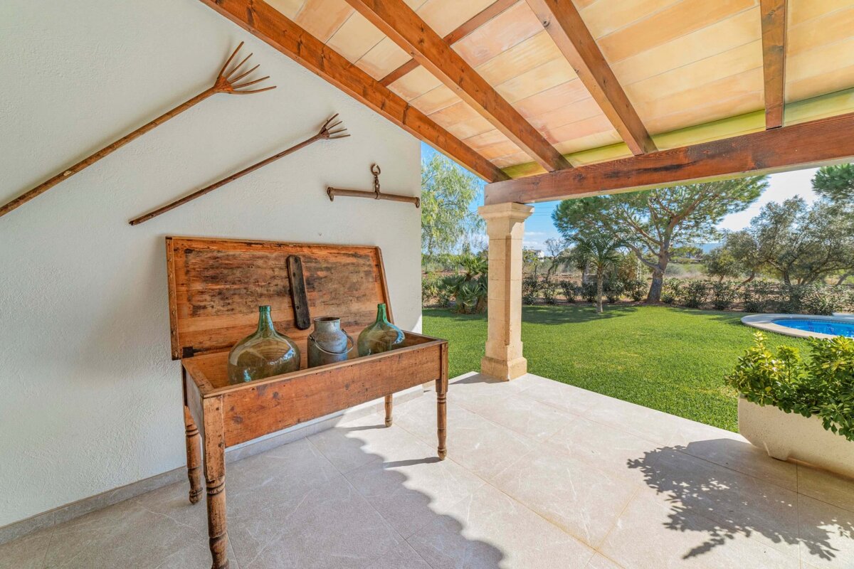A wooden table with vases and a rake on it