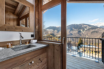 A bathroom with a sink and a view of the mountains