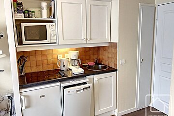 A small kitchen with a microwave and a coffee maker
