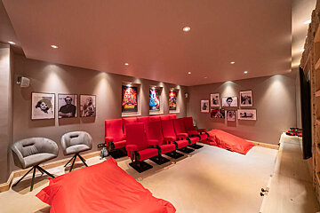 A room with red chairs and posters on the wall including one for star wars