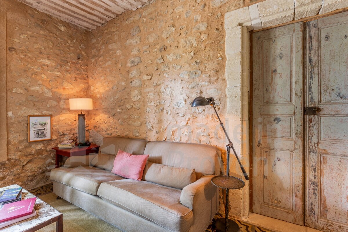 A living room with a stone wall and a couch