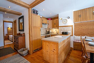 A bedroom with two beds and a wooden headboard
