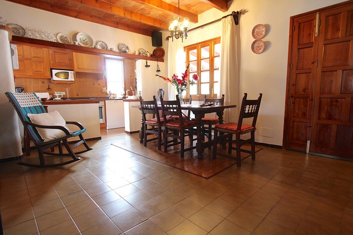 A rocking chair sits next to a table in a kitchen