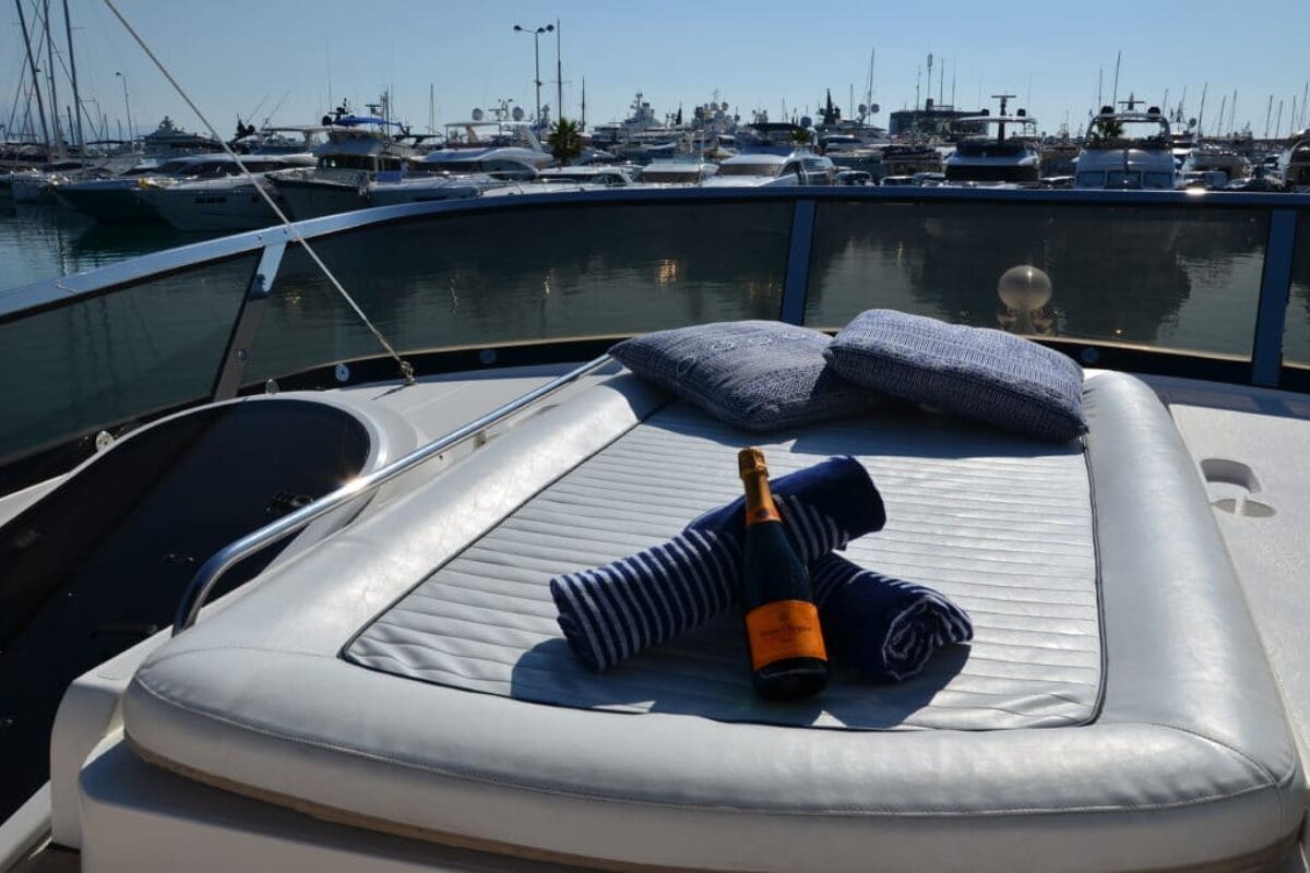 A bottle of veuve clicquot sits on the back of a boat