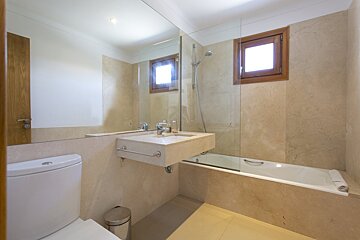 A bathroom with a toilet sink and bathtub