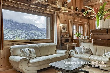 A living room with a couch and a table that says mountain base on it